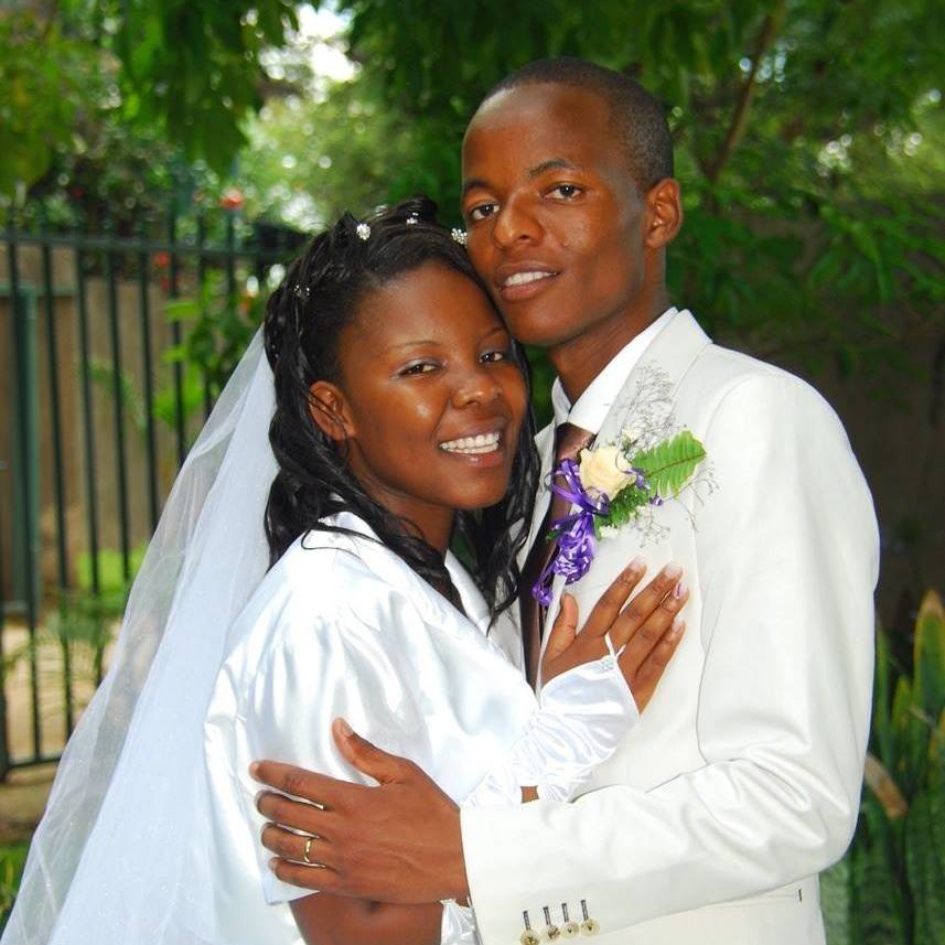 happy couple in wedding clothes hugging